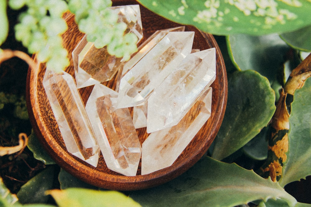 A bowl of crystals in a wooden bowl.